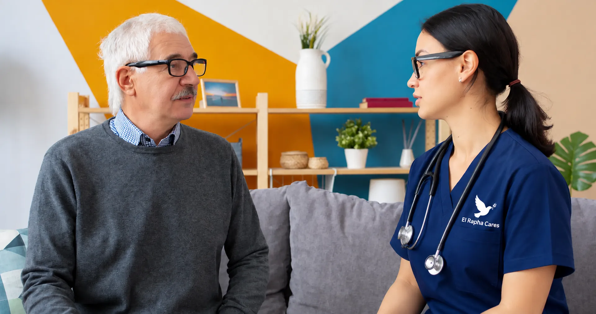 Nurse talking with an older man on a couch at home